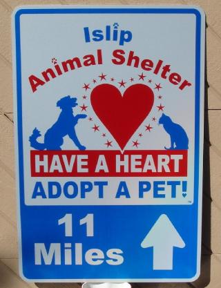 Town of Islip sign with arrow and distance Town of Islip sign with arrow and distance